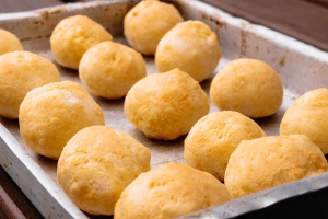 Pão de queijo de forno fofinho que parece nuvem e derrete na boca com queijo cremoso